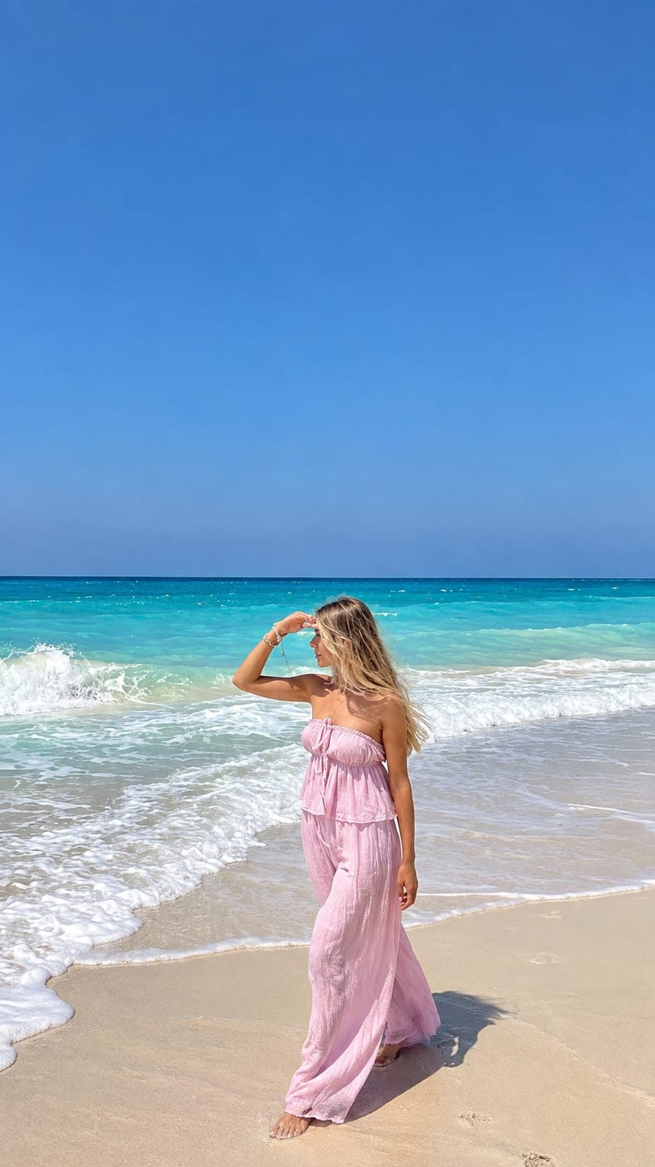 A woman enjoying the clear turquoise water and sandy beach on Egypt’s North Coast.