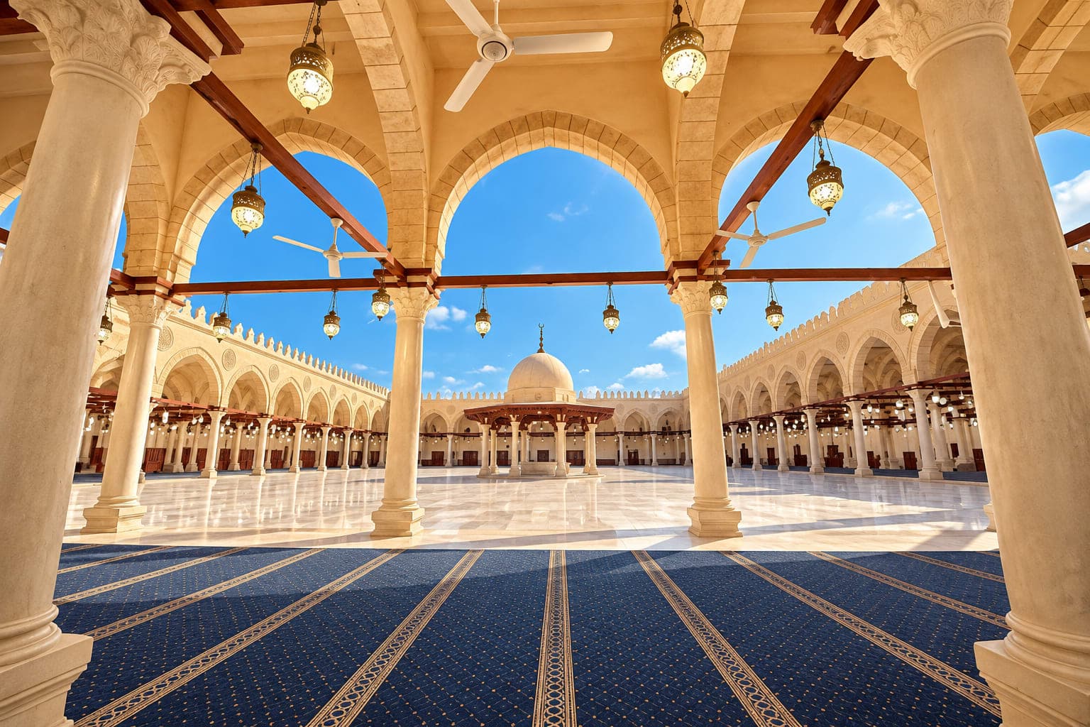 The beautiful courtyard of the Mosque of Amr ibn al-As in Old Cairo, featuring elegant arches, marble columns, and a clear blue sky.