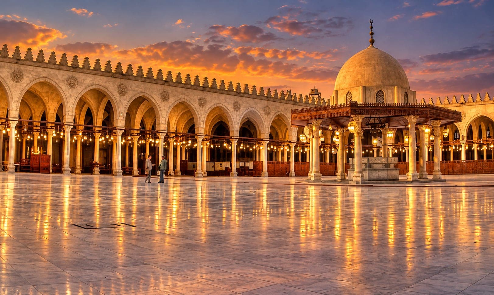 The Mosque of Amr ibn al-As illuminated at sunset, showcasing its historic courtyard, elegant arches, and domed architecture in Old Cairo.