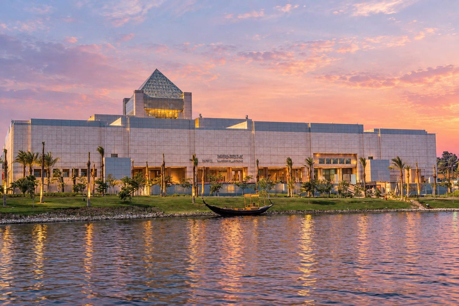 National Museum of Egyptian Civilization (NMEC) in Cairo overlooking a peaceful lake at sunset.